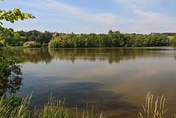 vtok Červeného potoka do rybníka Pazderny u budovy na protějším břehu