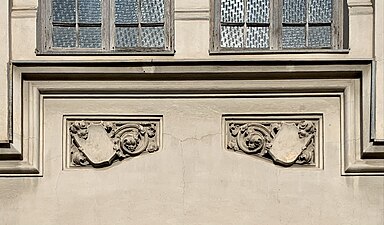 Gothic Revival shield-like cartouches on the Hermann I.Rieber carriage factory (Strada Romulus no. 17), Bucharest, by Siegfrid Kofczinsky, 1903[17]