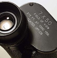 Parameters listed on the prism cover plate describing 7 power magnification binoculars with a 50 mm objective diameter and a 372 foot (113.39 m) field of view at 1,000 yards (914.4 m) Binoculars description plate2.jpg