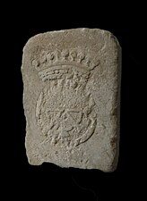 Raised stone on a black background, marked with a partially hammered crowned wheel.