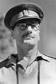 Brigadier R.J.H. Risson DSO, OBE, Chief Engineer, 2nd Australian Corp, watching a military demonstration of tank and infantry attack methods at Atherton Tablelands, QLD, 1943