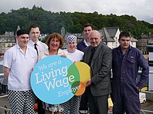 Government direction can help employers move towards offering a living wage. CalMac signs up for Living Wage (20658599598).jpg