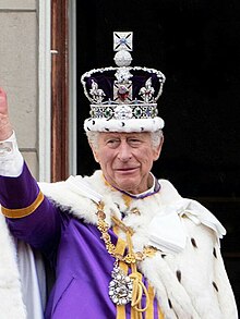 King Charles III (wearing the Imperial State Crown), the living embodiment of the state/crown in each of the Commonwealth realms Carl III af Det Forenede Kongerige.jpg