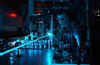 A military scientist operates a laser in a tes...