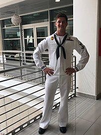 A US Navy Master-at-Arms third class in dress white uniform (2018) Navysailorindresswhites-2018.jpg