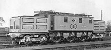 The North Eastern Railway's only express electric locomotive, in their fully-lined-out passenger livery. The centre cab section is only a little larger than the rectangular hoods at each end, with their prominent external maintenance hatches.