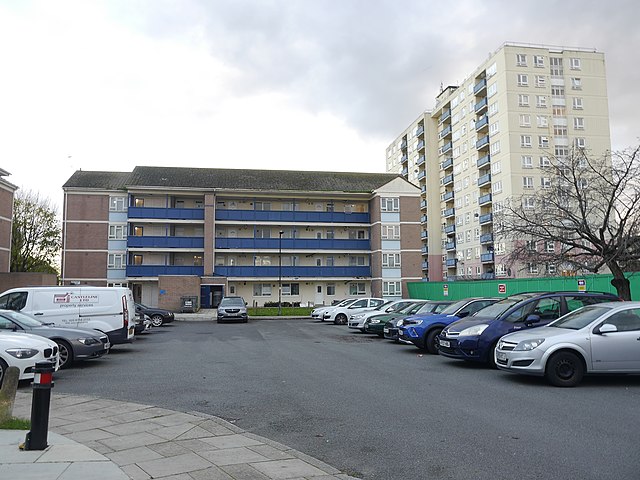 a four-storey block of flats with balconies projecting from the upper floors