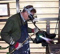 Gas welding a steel armature using the oxy-acetylene process.