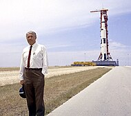 Dr. von Braun pauses in front of the Saturn V vehicle being readied for the Apollo 11 lunar landing mission at the Kennedy Space Center (KSC) in 1969