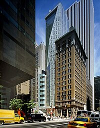 a tall blue glass building with angles