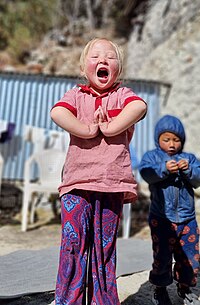 A little girl from Namche Bazaar, Nepal, expressing her happiness towards foreign visitors A little girl from Namche Bazaar, Nepal, expressing her happiness towards foreign visitors, photographed during the tour to the Mount Everest Base Camp, December 2, 2023.jpg