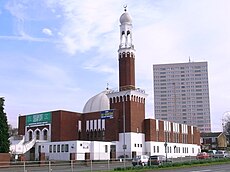 Birmingham Central Mosque, the first mosque in the United Kingdom to use loudspeakers to broadcast the adhan. Birmingham Central Mosque.jpg