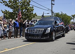 The funeral procession for Keating makes its way down Sixth Avenue in Coronado, California on its way to Fort Rosecrans National Cemetery. Hundreds of San Diego residents lined the streets to pay their respects to Keating.