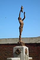 Dover War Memorial (1924), youth holding aloft a burning cross against a bright blue sky