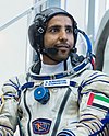 Hazza Al Mansouri in front of the Soyuz spacecraft simulator.jpg