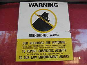English: A neighborhood watch sign attached to...