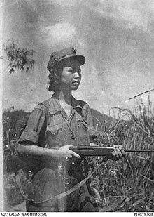 Leader of the Malayan Communist Party Lee Meng holding a rifle during the Malayan Emergency, 1951 Outdoor portrait of Lee Min, leader of the communist Kepayang Gang in the Ipoh district in 1951 (AWM 4281801).JPG