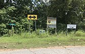 Minuscule sign, at left, pointing to Emmett Till Historic Intrepid Center, Glendora, Mississippi, 2019