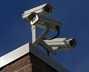 Three surveillance cameras on the corner of a ...