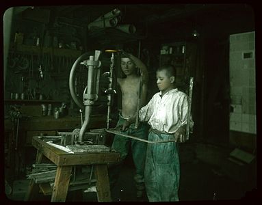 Two boys using drill press