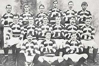 A team of rugby players posing in three rows wearing their playing uniform
