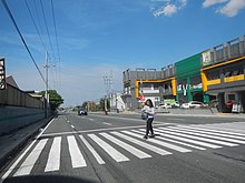 A woman at a marked crossing in Carmona, Philippines 4876Maduya, Carmona, Cavite Landmarks 33.jpg