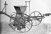 Gravure d'un semoir avec trois roues et sa trémie à l'arrêt