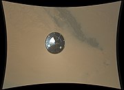 The 4.5 m (15 ft) diameter heat shield falls away from the rover, imaged by the Mars Descent Imager camera (MARDI) installed on bottom of Curiosity. Sol 0 (2012-08-06 05:15:30 UTC).