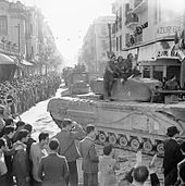 Churchill tank moves through Tunis during the liberation, 8 May 1943 A Churchill tank and other vehicles parade through Tunis, 8 May 1943. NA2880.jpg