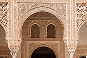 Marble capitals and stucco decoration of the portico and the doorways behind it