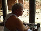 2. A little wearily, a man watches the on-going construction of his house in Chandesh, Bihar.