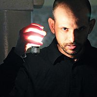 Achraf Baznani holds a lamp, 2014