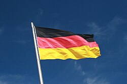 German Flag Flying aganist a Blue Sky.jpg