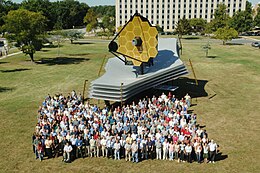Early full-scale model on display at NASA Goddard Space Flight Center (2005) JWST people.jpg