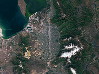 Salt Lake Valley from space, bounded on the west by the Oquirrh Mountains, the northwest by the Great Salt Lake, and on the east by the Wasatch Mountains. Salt Lake City occupies roughly the northern quarter of the valley.