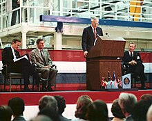 NASA Administrator address the crowd at the Spacelab arrival ceremony in February 1982. On the podium with him is then-Vice President George Bush, the director general of European Space Agency (ESA), Eric Quistgaard, and director of Kennedy Space Center Richard G. Smith Spacelab Arrival Ceremony at Kennedy Space Center - GPN-2002-000088.jpg