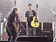 Dallas Schoo avec The Edge au cours d'un échange de guitares sur la scène du Vertigo Tour de U2 à Rome le samedi 23 juillet 2005.