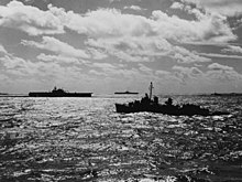Black and white photo of three warships at sea