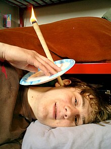 Attempting the procedure Ear candling-self applied.jpg