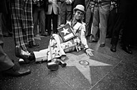 Known for his flamboyant style and virtuosic piano playing, Elton John became one of the biggest pop stars of the 1970s. Elton John receiving his star on the Hollywood Walk of Fame.jpg