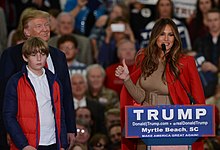 Melania at a campaign event with Donald and Barron in November 2015 First Lady Melania Trump speaking in 2015 (cropped2).jpg