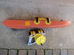 Side view of float with handheld GPS in waterproof box with ratchet reel