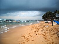 Hikkaduwa Beach with Coral viewing and Fishing boats in the background