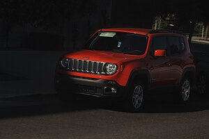 Red_Jeep_Renegade_Parked_in_Shadow_of_Building