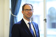 Head-and-shoulders colour photograph of Tobias Ellwood in July 2014.