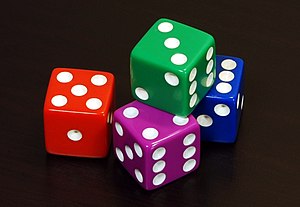 English: Four coloured 6 sided dice arranged i...