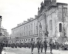 A U.S. Army band leads the entrance of American troops into Verdun, France in 1944. Army Band, Verdun, France (6732417807).jpg