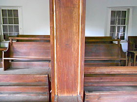 Interior showing the "facing benches" for the elders and the moving divider sometimes used to separate the men's and women's meetings