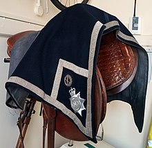 Horse saddle used by the West Midlands Police's mounted unit. Horse saddle and cloth WP Police ACC rank.jpg