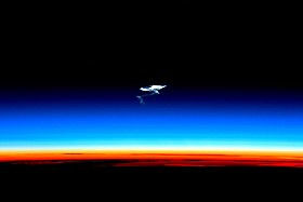 Afterglow of the troposphere (orange), the stratosphere (blue) and the mesosphere (dark) at which atmospheric entry begins, leaving smoke trails, such as in this case of a spacecraft reentry ISS-46 Soyuz TMA-17M reentry.jpg